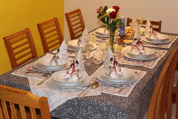 Festively set table for eight people, Christmas home environment