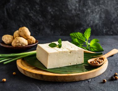 Koyu arkaplanda soya peyniri. Bu resim yapay zekayla oluşturuldu ve bir referans resmi kullanıldı.