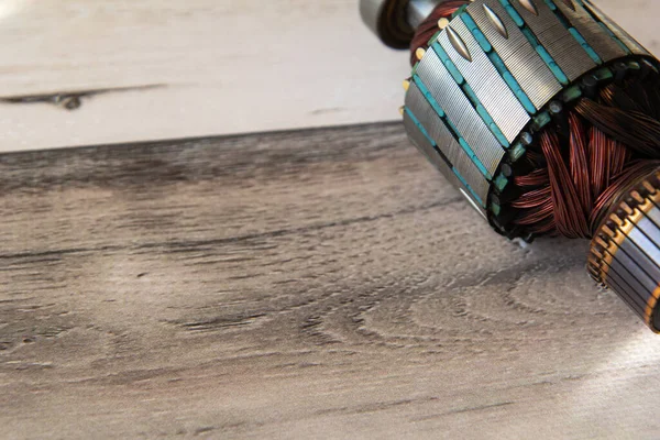 stock image Close up view of electric motor rotor wooden background. Copy space