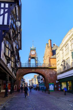 Chester, İngiltere - 10 Ekim 2022: Chester, Cheshire, İngiltere, İngiltere 'de yerel halk ve ziyaretçilerle birlikte Doğu Geçidi, Doğu Saati ve Saflar tarihi caddesinin görüntüsü