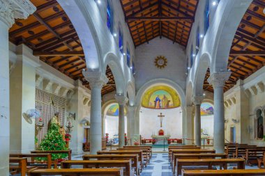 Nazareth, Israel - January 06, 2023: View of the interior of Saint Joseph church (Basilica of the Annunciation compound), with a Christmas tree, in Nazareth, Israel