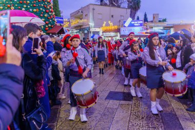 Nazareth, Israel - January 06, 2023: Orthodox Christmas Eve parade, with participants and crowd, in Nazareth, Israel