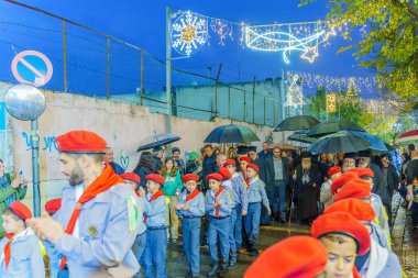Nazareth, Israel - January 06, 2023: Orthodox Christmas Eve parade, with the patriarch, participants, and crowd, in Nazareth, Israel