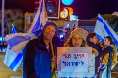 Haifa, Israel - January 14, 2023: People protest with signs against the legislative plans of the new government, in Haifa, Israel
