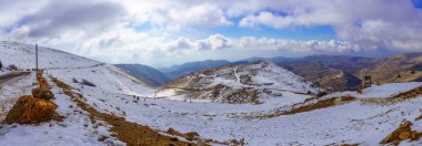 Neve Ativ, Israel - January 18, 2023: Panoramic view of snowy landscape of Mount Hermon, with visitors, in the north part of the Golan Heights, Northern Israel