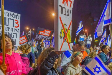 Haifa, Israel - January 28, 2023: Crowd of protesters with various signs and flags attend a demonstration in against the plans of the new government, claiming its anti-democratic, in Haifa, Israel