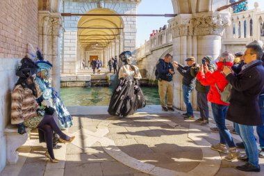 Venedik, İtalya - 01 Mart 2022: Venedik Maskeli Karnavalı 'nın bir parçası olan Riva degli Schiavoni rıhtımında geleneksel kostümlü bir grup