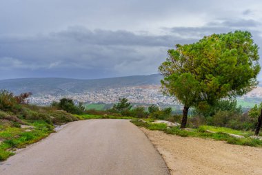 View of Lower Galilee landscape, and the Arab town Turan in the background, on a foggy winter day. Northern Israel