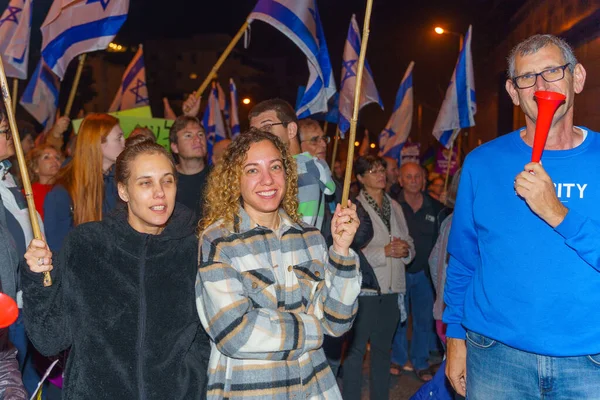 stock image Haifa, Israel - March 04, 2023: Protesters with various signs and flags attend a demonstration against the plans of the new government, claiming its anti-democratic, in Haifa, Israel