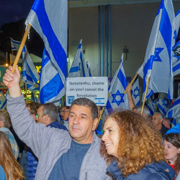 stock image Haifa, Israel - March 25, 2023: Protesters with various signs and flags attend a demonstration against the plans of the new government, claiming its anti-democratic, in Haifa, Israel