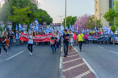 Hayfa, İsrail - 22 Nisan 2023: Hayfa, İsrail 'de antidemokratik olduğunu iddia eden hükümetin planlarına karşı çeşitli pankartlar, pankartlar ve bayraklarla protesto yürüyüşü