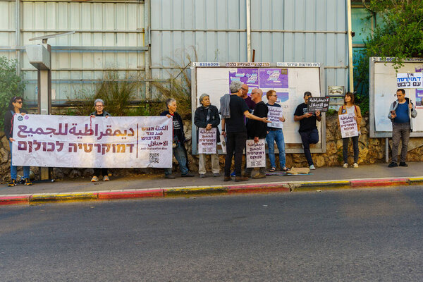 Haifa, Israel - April 22, 2023: Protest march with various banners, signs, and flags as demonstration against the occupation and the plans of the government, in Haifa, Israel