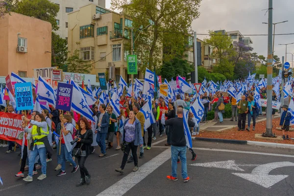 stock image Haifa, Israel - May 13, 2023: People marching with flags and various signs. 19th week of anti-government protest in Haifa, Israel