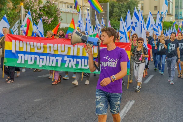 stock image Haifa, Israel - June 24, 2023: People marching with flags and various signs. Week 25 of anti-government protest in Haifa, Israel