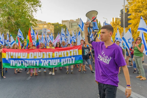 stock image Haifa, Israel - June 24, 2023: People marching with flags and various signs. Week 25 of anti-government protest in Haifa, Israel