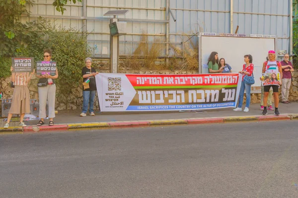 stock image Haifa, Israel - July 01, 2023: Group of people with anti-occupation signs. Week 26 of anti-government protest in Haifa, Israel