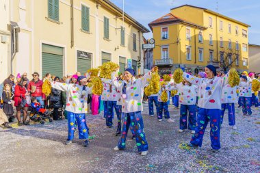 Cantu, Italy - February 25, 2023: Carnival parade, dancers group, and crowd, in Cantu, Lombardy, Northern Italy clipart