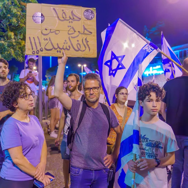 stock image Haifa, Israel - July 11, 2023: People protest with flags and various signs. Part of day of disruption against controversial judicial overhaul, in Haifa, Israel