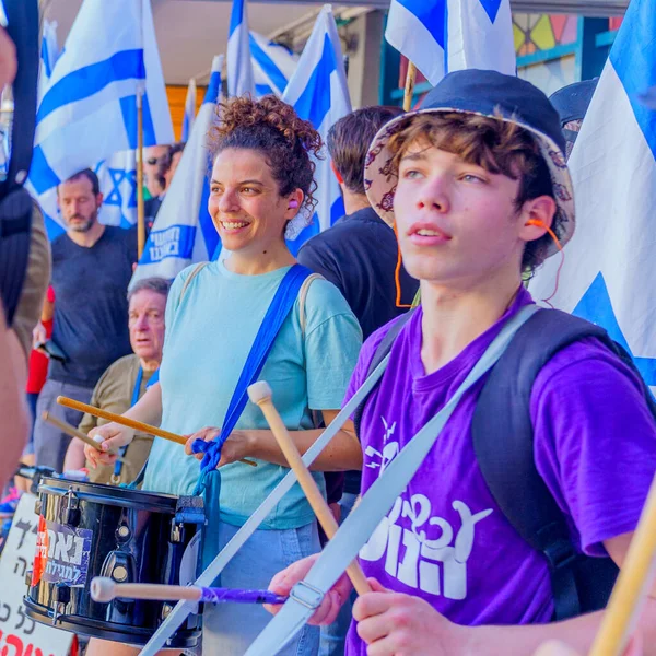 stock image Haifa, Israel - July 18, 2023: People protest with flags and various signs in a train station. Part of day of disruption against controversial judicial overhaul, in Haifa, Israel