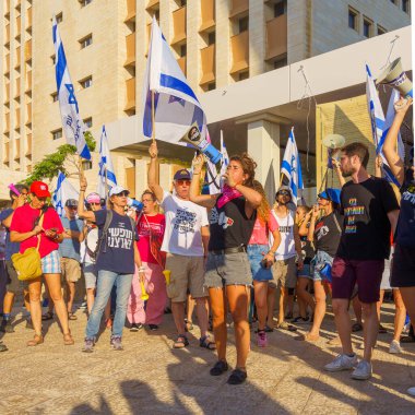 Haifa, Israel - July 20, 2023: People protest with flags and various signs in a government compound. Part of a protest against controversial judicial overhaul, in Haifa, Israel
