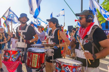 Haifa, Israel - July 20, 2023: People protest with drums in a government compound. Part of a protest against controversial judicial overhaul, in Haifa, Israel