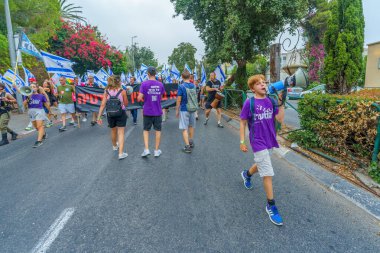 Hayfa, İsrail - 12 Ağustos 2023: İnsanlar çeşitli bayrak ve işaretlerle yürüyor. Tartışmalı adli elden geçirme karşıtı 32. hafta protestosu. Hayfa, İsrail