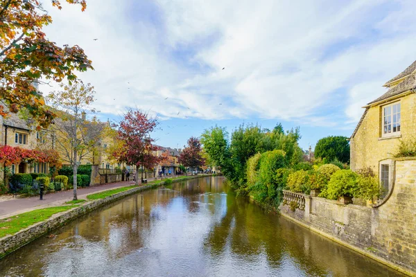 Bourton-on-the-Water, İngiltere - 17 Ekim 2022: Tipik evler, Windrush nehri, yerliler ve ziyaretçiler, Bourton-on-the-Water, Cotswolds bölgesi, İngiltere, İngiltere