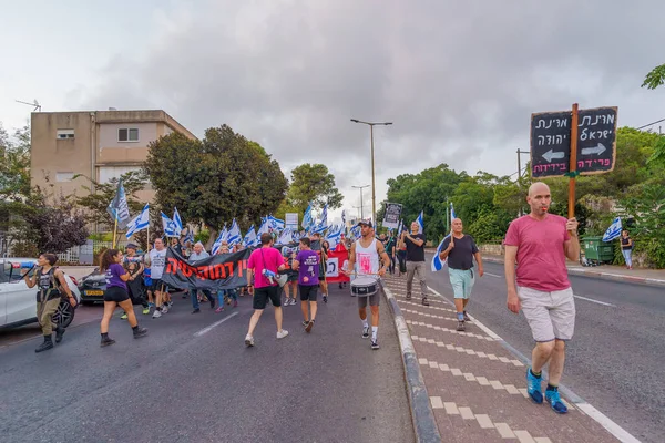 stock image Haifa, Israel - September 09, 2023: People march with various signs and flags, led by banner supporting supreme court. Week 36 of protest against controversial judicial overhaul. Haifa, Israel