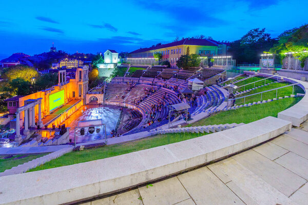 Plovdiv, Bulgaria - September 24, 2023: Evening view of the Ancient Roman Theater of Philippopolis, with visitors, in Plovdiv, Bulgaria