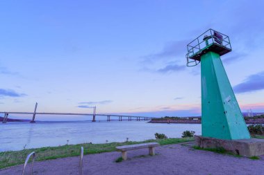 Carnarc Point Kulesi 'nin günbatımı manzarası ve İngiltere, İskoçya' da Beauly Firth 'ün karşısındaki Kessock Köprüsü.