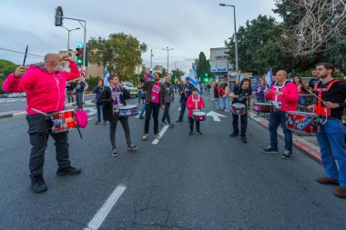 Hayfa, İsrail - 16 Mart 2024: İnsanlar hükümete karşı çeşitli tabelalar ve bayraklarla bir protesto yürüyüşüne katılarak yeni seçimler çağrısında bulundu. Hayfa, İsrail