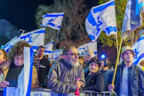 stock image Haifa, Israel - March 16, 2024: Crowd of people with various signs and flags protest against the government, calling for new elections. Haifa, Israel