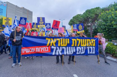 Hayfa, İsrail - 13 Nisan 2024: İnsanlar hükümete karşı çeşitli tabela ve bayraklarla bir protesto yürüyüşüne katılarak yeni seçimler çağrısında bulundu. Hayfa, İsrail