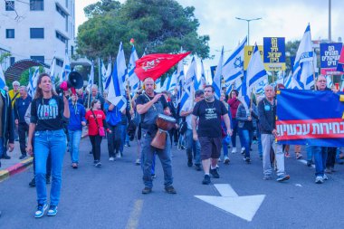 Hayfa, İsrail - 13 Nisan 2024: İnsanlar hükümete karşı çeşitli tabela ve bayraklarla bir protesto yürüyüşüne katılarak yeni seçimler çağrısında bulundu. Hayfa, İsrail