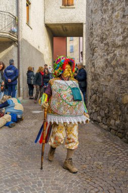 Schignano, Italy - February 18, 2023: Participant in traditional costume and mask of Mascarun (lucky, rich), part of the traditional carnival of Schignano, Lake Como, Lombardy, Northern Italy clipart