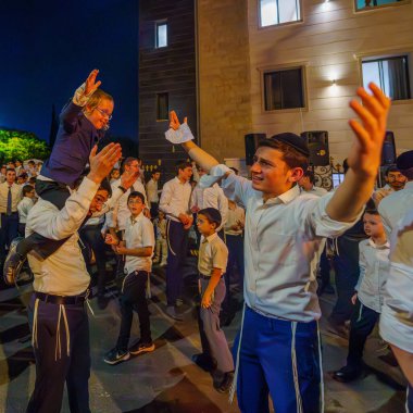 Hayfa, İsrail - 25 Mayıs 2024: Ultra-Ortodoks Yahudiler, İsrail 'in Hayfa kentinde bir ateşin yanında dans ederek Geleneksel Lag-BaOmer Bayramını kutladılar