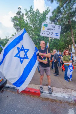 Hayfa, İsrail - 25 Mayıs 2024: Çeşitli tabela ve bayraklara sahip insanlar hükümeti protesto ederek yeni seçim çağrısında bulundular. Hayfa, İsrail