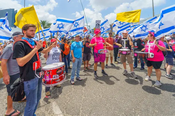 stock image Haifa, Israel - July 07, 2024: People protest with flags, various signs, blocking a major junction. Part of day of disruption against the government and support of hostages families, Haifa, Israel