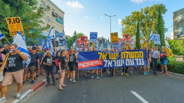 Hayfa, İsrail - Temmuz 06, 2024: Hükümete karşı bir protesto yürüyüşü sahnesi, insanların katıldığı, çeşitli tabelalar ve bayraklarla yeni seçimler çağrısında bulundu. Hayfa, İsrail