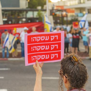 Hayfa, İsrail - 17 Temmuz 2024: Çeşitli tabelaları ve bayrakları olan insanlar, ABD 'ye gitmeden önce rehine anlaşması çağrısında bulunarak hükümete karşı düzenlenen bir protestoya katıldılar. Hayfa, İsrail