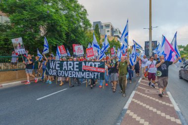 Hayfa, İsrail - 20 Temmuz 2024: Bir protesto yürüyüşü sahnesi, hükümete karşı, insanların katıldığı, çeşitli tabelalar ve bayraklarla yeni seçimler çağrısında bulundu. Hayfa, İsrail