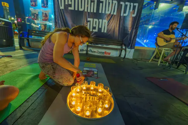 stock image Haifa, Israel - July 24, 2024: 12 candles to mark 120 hostages, part of a Yoga session to honor Carmel Gat, a yoga instructor held hostage by Hamas. Carmel Center, Haifa, Israel