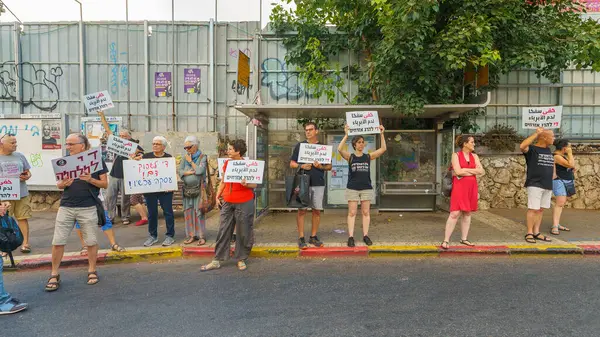 stock image Haifa, Israel - August 10, 2024: People with signs calling to stop the war, peace talk, and hostage deal, part of a protest rally, Haifa, Israel