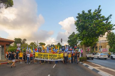 Hayfa, İsrail - 24 Ağustos 2024: Hükümete karşı bir protesto yürüyüşü sahnesi, insanların katıldığı, çeşitli tabelalar ve bayraklarla yeni seçimler çağrısında bulundu. Hayfa, İsrail
