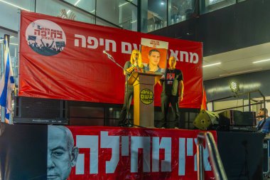 Haifa, Israel - September 07, 2024: Osnat Getz, aunt of Omer Neutra who is hostage of Hamas, speaks to the crowd, part of a protest march against the government, Haifa, Israel clipart