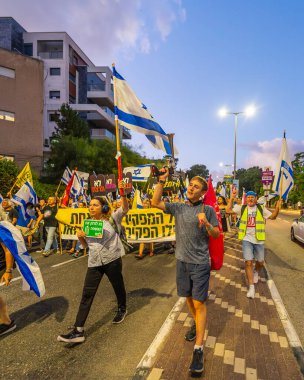 Hayfa, İsrail - 14 Eylül 2024: Hükümete karşı bir protesto yürüyüşü sahnesi, yeni seçimler ve insanların yer aldığı bir rehine anlaşması, çeşitli tabelalar ve bayraklar. Hayfa, İsrail