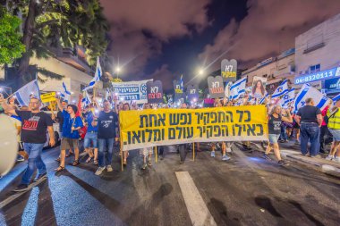 Hayfa, İsrail - 21 Eylül 2024: Hükümete karşı bir protesto yürüyüşü sahnesi, yeni seçimler ve insanların yer aldığı bir rehine anlaşması, çeşitli tabelalar ve bayraklar. Hayfa, İsrail