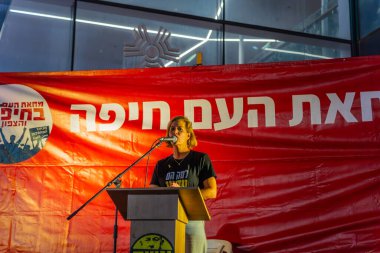 Haifa, Israel - September 21, 2024: Carmit Palty Katzir, speaks to the crowd, part of a protest rally calling for new elections and a hostage deal, Haifa, Israel clipart