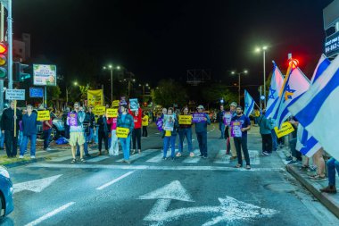 Haifa, Israel - November 16, 2024: People protest in the street, support of the hostages, calling for a deal, in Haifa, Israel clipart