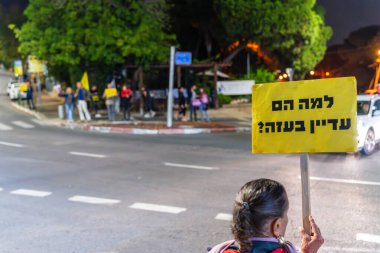 Haifa, Israel - November 23, 2024: People protest in the street, support of the hostages, calling for a deal, in Haifa, Israel clipart